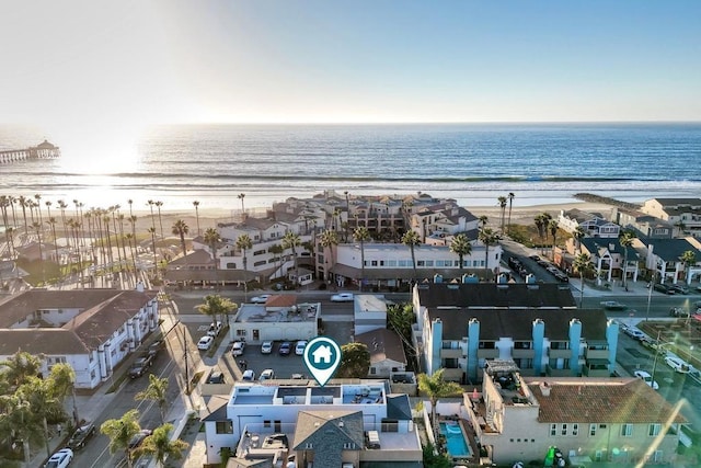 drone / aerial view featuring a water view and a view of the beach