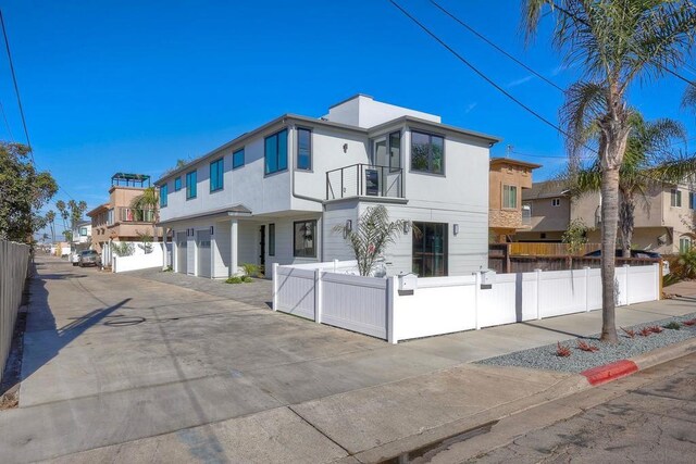 contemporary home with a balcony and a garage