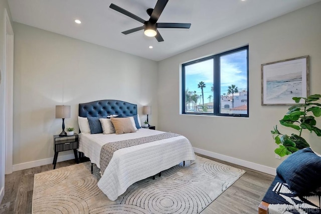 bedroom with ceiling fan and wood-type flooring