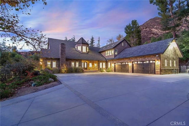 view of front facade with a garage and a mountain view