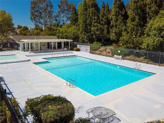 view of swimming pool featuring a patio