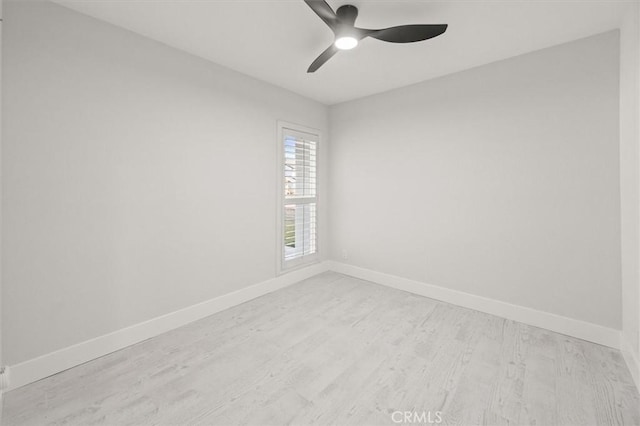 empty room with light wood-type flooring and ceiling fan