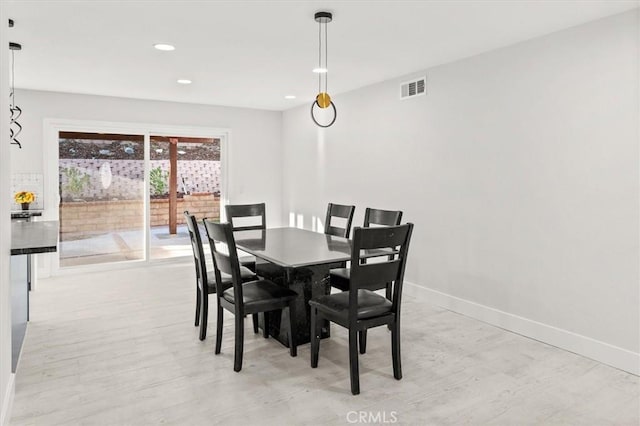 dining space featuring light wood-type flooring