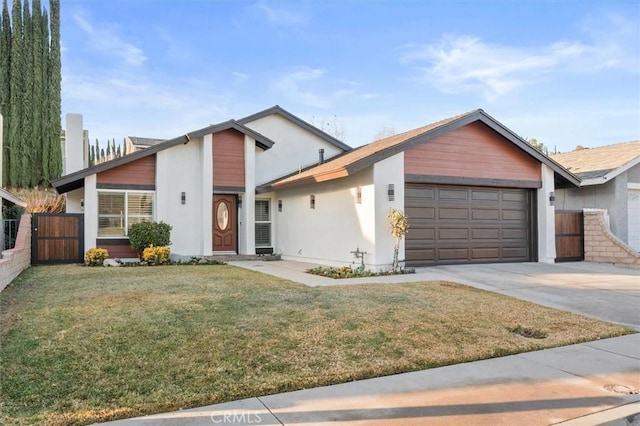 view of front of house with a front yard and a garage