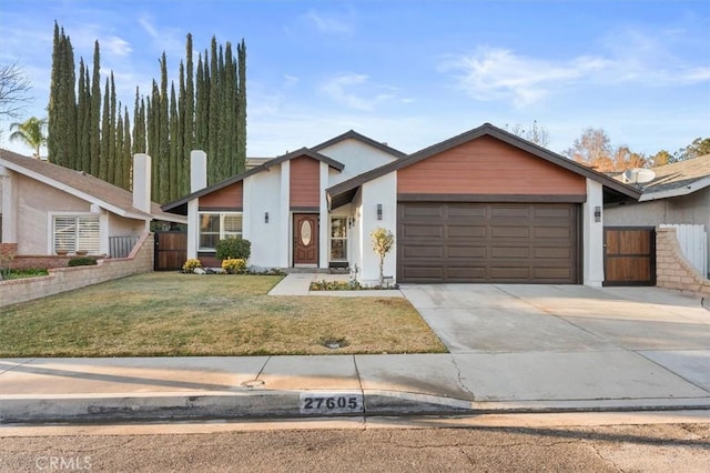 view of front of property with a garage and a front yard