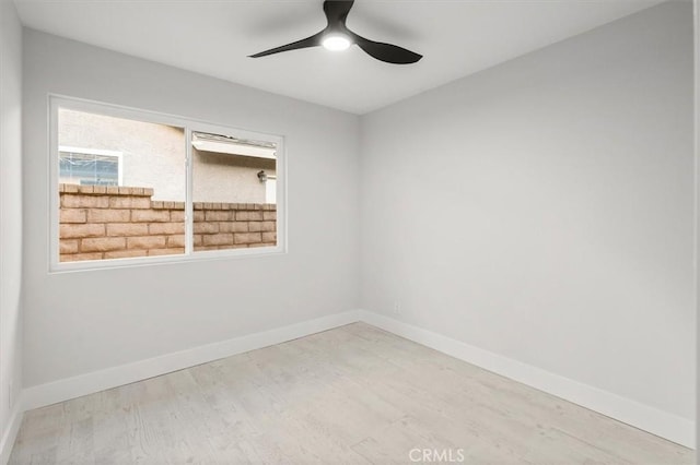 empty room with ceiling fan and light hardwood / wood-style floors