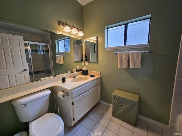 bathroom featuring toilet, tile patterned flooring, a shower with shower door, and vanity