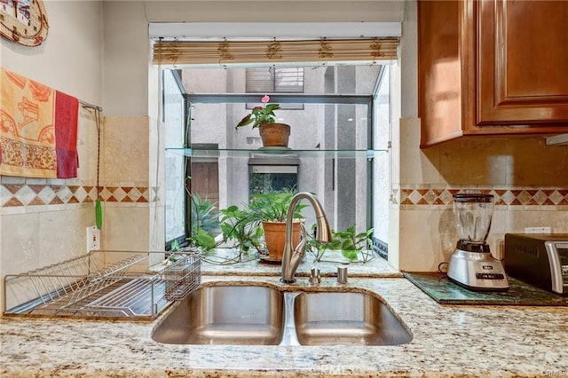 kitchen with sink and light stone counters