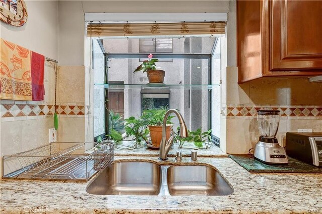 14326 Chandler Blvd Unit 5, Sherman Oaks, CA 91401 - kitchen featuring brown cabinetry, a sink, and light stone countertops