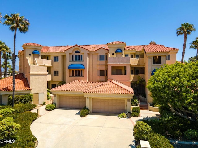 mediterranean / spanish home with a garage