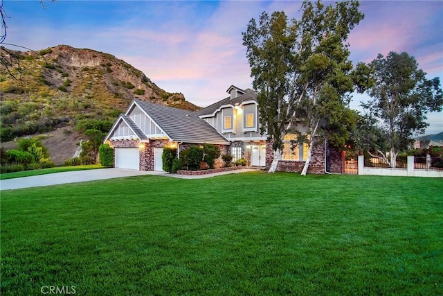 view of front of home featuring a mountain view and a yard