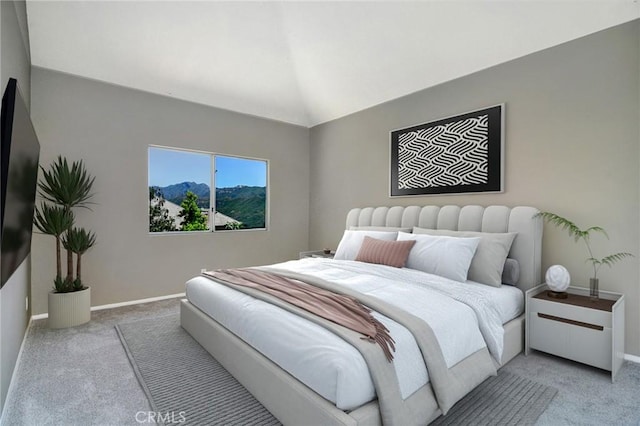 carpeted bedroom with lofted ceiling