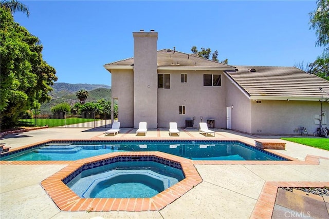 view of pool featuring central AC, a mountain view, and an in ground hot tub