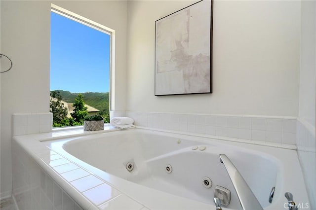 bathroom featuring tiled tub