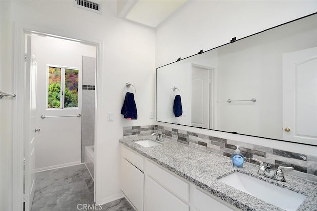 bathroom featuring shower / tub combination, tasteful backsplash, and vanity