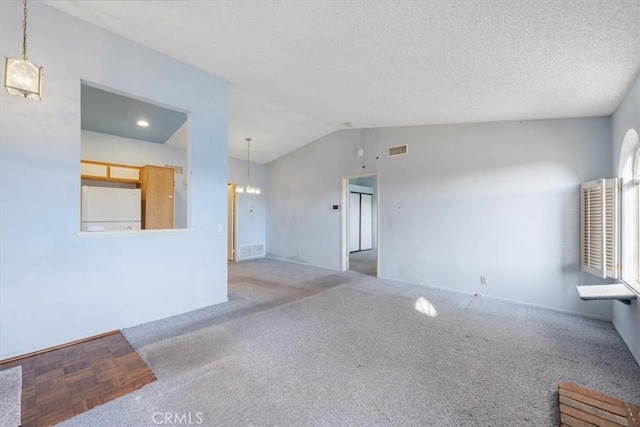 empty room featuring lofted ceiling and a textured ceiling