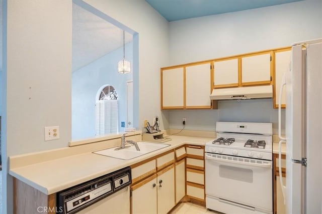 kitchen featuring hanging light fixtures, sink, and white appliances