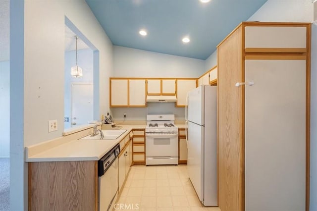 kitchen with decorative light fixtures, sink, white appliances, and vaulted ceiling