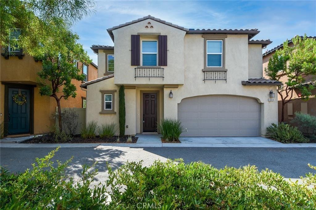 mediterranean / spanish house with a garage