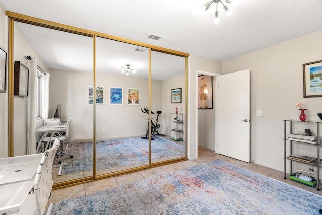 tiled bedroom with a closet