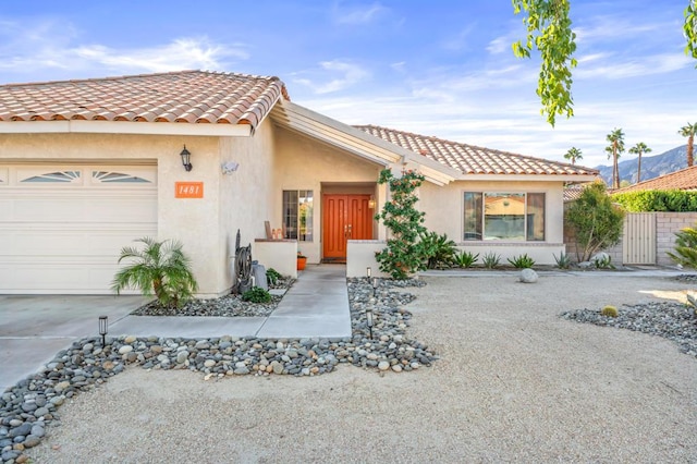 mediterranean / spanish-style house with a garage