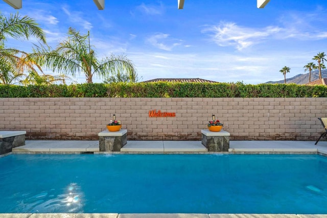 view of swimming pool with pool water feature