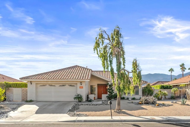 view of front facade with a garage and a mountain view