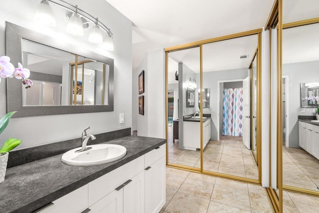 bathroom with vanity, a shower with curtain, and tile patterned floors