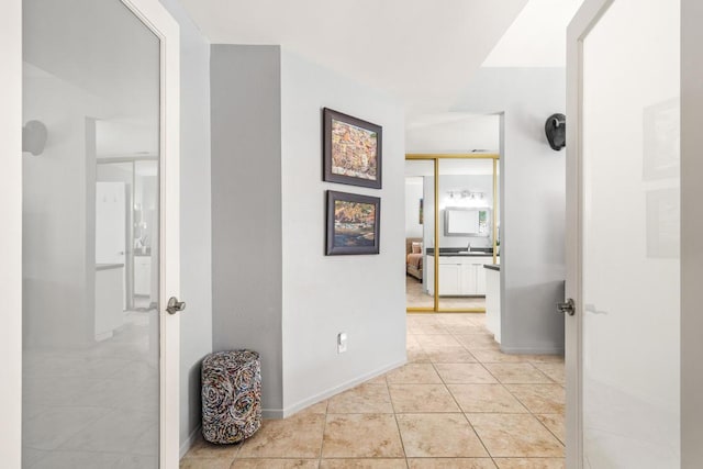 corridor with light tile patterned flooring