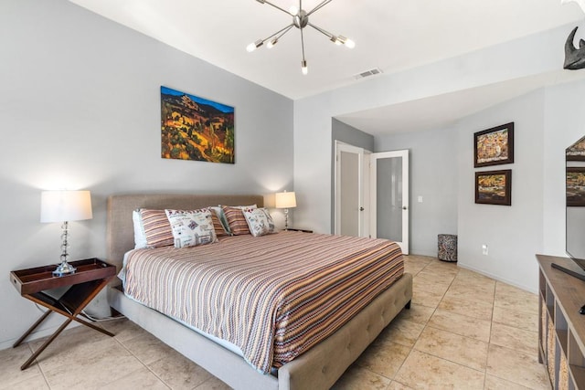 bedroom featuring light tile patterned floors and an inviting chandelier