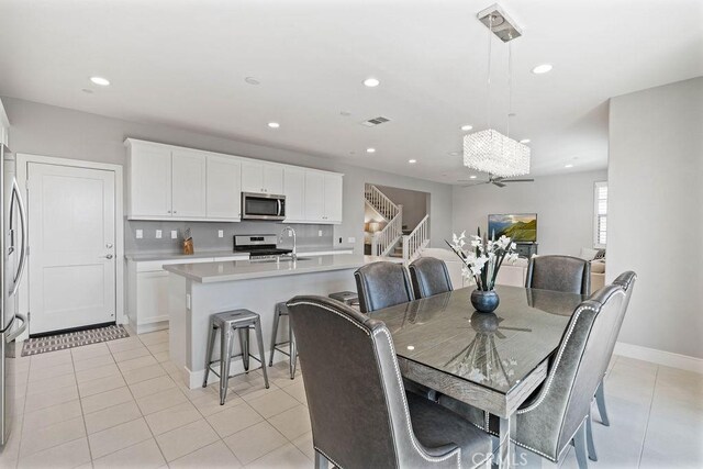 dining area featuring light tile patterned flooring, stairs, visible vents, and recessed lighting