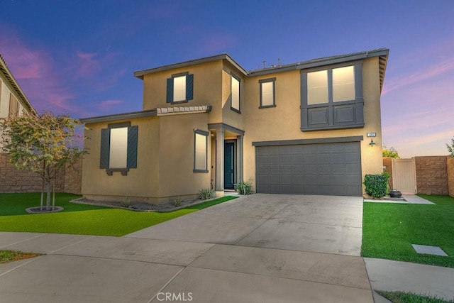 4062 E Fincastle St, Ontario, CA 91761 - view of front of home with stucco siding, concrete driveway, an attached garage, a front yard, and fence