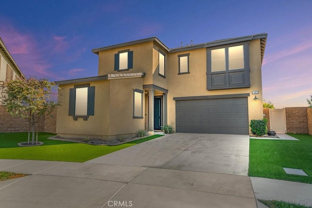 view of front of home with stucco siding, concrete driveway, an attached garage, a front yard, and fence