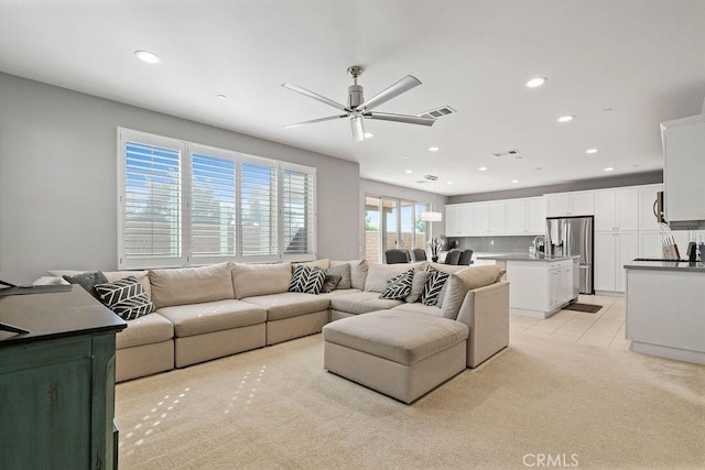 carpeted living room featuring ceiling fan