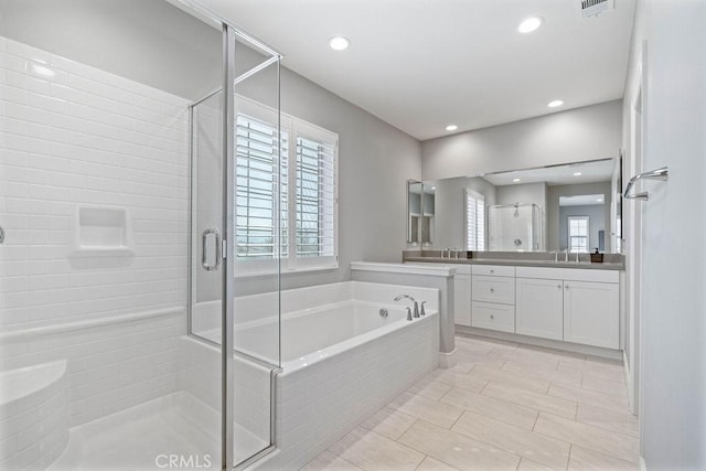 full bathroom with a stall shower, a garden tub, vanity, and recessed lighting