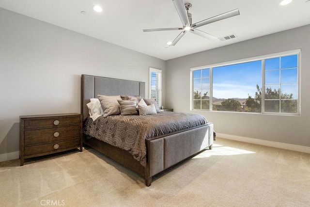 bedroom featuring ceiling fan and light carpet