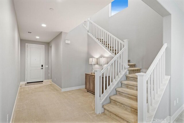 stairway with recessed lighting, carpet, and baseboards