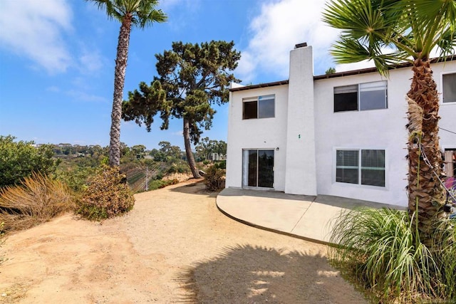 back of property featuring a patio