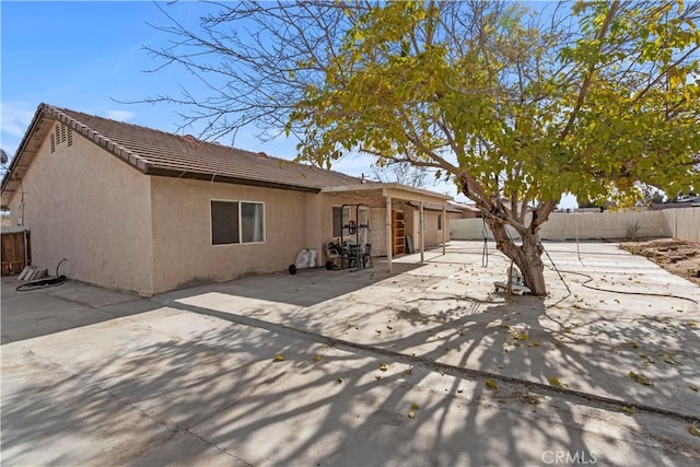 back of house with a patio