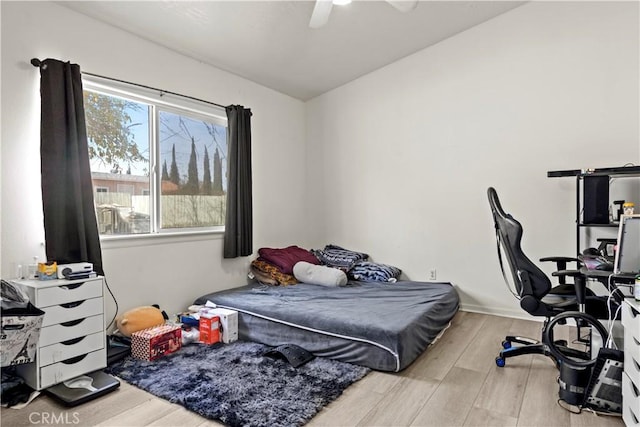 bedroom with ceiling fan and light hardwood / wood-style floors