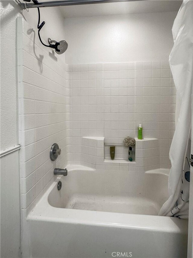 bathroom with shower / bathtub combination with curtain