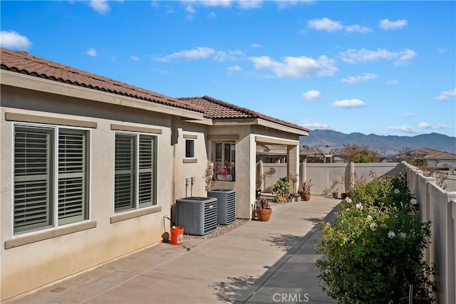 view of patio / terrace featuring a mountain view and central air condition unit