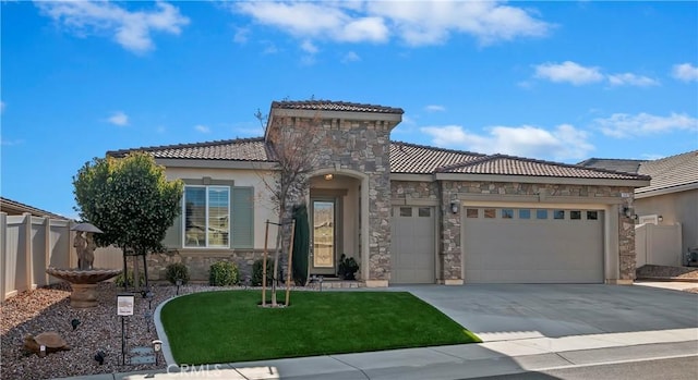 mediterranean / spanish-style home featuring a front yard and a garage