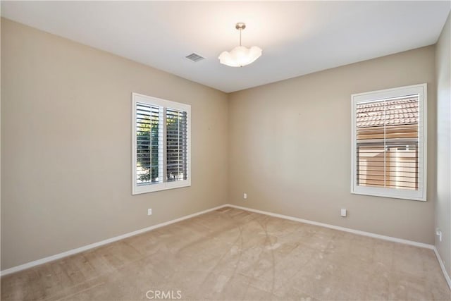 empty room featuring light carpet