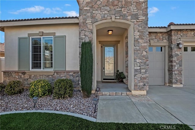 doorway to property with a garage