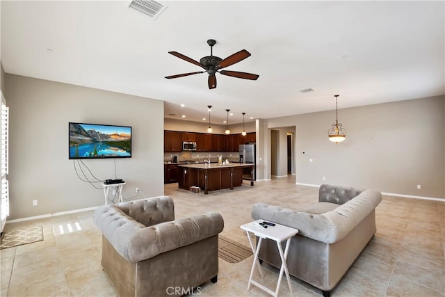 tiled living room featuring ceiling fan