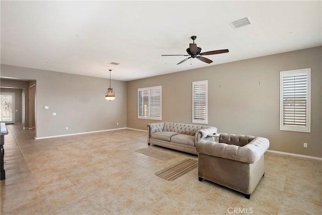 living room featuring ceiling fan and plenty of natural light