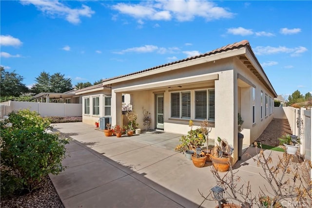 back of house featuring cooling unit and a patio