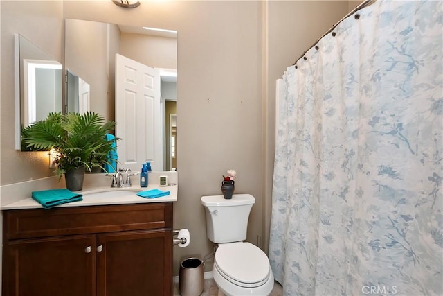 bathroom with toilet and vanity