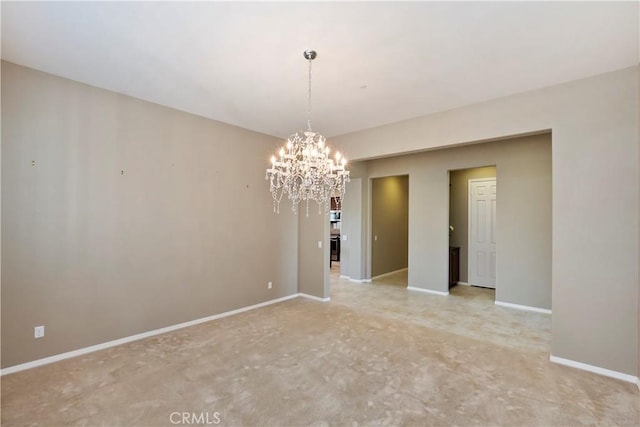 spare room with a notable chandelier